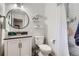 Updated bathroom featuring a modern vanity, sleek fixtures, and a shower with white subway tile at 9580 W 12Th Pl, Lakewood, CO 80215