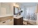 Bathroom featuring a vanity with a decorative shower curtain and plants at 9580 W 12Th Pl, Lakewood, CO 80215