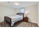 Cozy bedroom with soft lighting and a comfortable wooden frame bed at 9580 W 12Th Pl, Lakewood, CO 80215