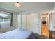 Bright bedroom with sliding door closet and view of hallway at 9580 W 12Th Pl, Lakewood, CO 80215