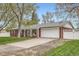 Charming brick home with a two-car garage, well-manicured lawn, and inviting curb appeal at 9580 W 12Th Pl, Lakewood, CO 80215