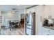 Well-designed kitchen with stainless steel refrigerator open to eat in dining area with great natural light at 9580 W 12Th Pl, Lakewood, CO 80215