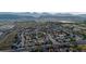 Expansive aerial view of a neighborhood with a mountain backdrop and autumn foliage at 6512 S Taft Way, Littleton, CO 80127