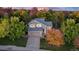 Beautiful aerial view of a gray home surrounded by colorful autumn trees at 6512 S Taft Way, Littleton, CO 80127