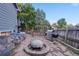 Spacious backyard featuring a stone patio with a fire pit, grill, and space for outdoor games at 6512 S Taft Way, Littleton, CO 80127