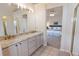 Bathroom featuring a double sink vanity and shower tub combo with glass doors at 6512 S Taft Way, Littleton, CO 80127