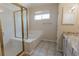 Bathroom featuring a shower, tub, vanity, and natural light from the window at 6512 S Taft Way, Littleton, CO 80127
