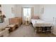 bedroom features a crib, twin size bed, and small table with lamp at 6512 S Taft Way, Littleton, CO 80127