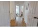 Hallway view leading to a bedroom, showcasing hardwood floors and white doors at 6512 S Taft Way, Littleton, CO 80127