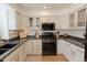 Well-equipped kitchen with modern appliances, stylish cabinetry, and ample counter space at 6512 S Taft Way, Littleton, CO 80127