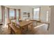 Bright and airy room with a dining table, bench seating, and built in shelves by the window at 6512 S Taft Way, Littleton, CO 80127