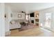 Comfortable living room with a fireplace, large sectional sofa, and access to the backyard at 6512 S Taft Way, Littleton, CO 80127