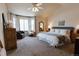 Spacious main bedroom features a large window and plush carpet at 6512 S Taft Way, Littleton, CO 80127