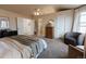 Spacious main bedroom features a chair, multiple closets, and large bed at 6512 S Taft Way, Littleton, CO 80127