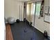 Home gym with black floors and gym equipment, featuring a large window at 1207 Joliet St, Aurora, CO 80010