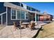 Backyard patio with a fire pit and view of the home's exterior at 6526 N Windfield Ave, Parker, CO 80134