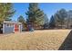 Spacious backyard with shed, play set, trampoline, and mature trees at 6526 N Windfield Ave, Parker, CO 80134