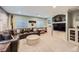 Finished basement with a large sectional sofa, built-in shelving, and a unique aviation themed decor at 6526 N Windfield Ave, Parker, CO 80134