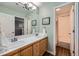 Bright bathroom features double sink vanity with wooden cabinets and a shower and tub combo at 6526 N Windfield Ave, Parker, CO 80134