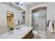 Well-lit bathroom featuring a glass-enclosed shower and a vanity with a decorative tiled backsplash at 6526 N Windfield Ave, Parker, CO 80134