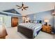 Comfortable bedroom features vaulted ceiling, blue walls, and a spacious layout with a leather bed frame at 6526 N Windfield Ave, Parker, CO 80134