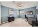 Versatile bedroom features neutral carpet, gray walls, and a functional desk and storage for optimal productivity at 6526 N Windfield Ave, Parker, CO 80134