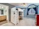Charming bedroom offers a loft bed with desk area and blue walls, with ensuite bathroom at 6526 N Windfield Ave, Parker, CO 80134