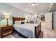 Comfortable bedroom showcasing a wooden bed frame, neutral carpet, and a doorway to another room at 6526 N Windfield Ave, Parker, CO 80134