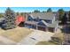 Expansive aerial view of a two-story home with a large driveway and mature trees at 6526 N Windfield Ave, Parker, CO 80134