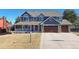 Charming two-story home featuring a covered porch, well-manicured lawn, and a convenient two-car garage at 6526 N Windfield Ave, Parker, CO 80134
