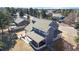 Aerial view of home with large back deck and patio seating, surrounded by mature trees at 6526 N Windfield Ave, Parker, CO 80134