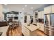 Open concept kitchen with stainless appliances flows to dining and living areas at 6526 N Windfield Ave, Parker, CO 80134