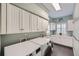Well-organized laundry room featuring modern appliances, ample storage cabinets, and practical design at 6526 N Windfield Ave, Parker, CO 80134