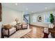 Comfortable living room with neutral tones, hardwood floors, and a piano at 6526 N Windfield Ave, Parker, CO 80134