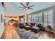 Open concept living room with lots of natural light, hardwood flooring, and dark accent wall at 6526 N Windfield Ave, Parker, CO 80134