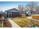 A spacious backyard with a detached garage and pathway, perfect for outdoor enjoyment at 722 Hutchinson St, Louisville, CO 80027