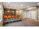 Basement bar with orange barstools, wood detail, and access to basement at 722 Hutchinson St, Louisville, CO 80027