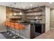 Finished basement bar with rustic wood detail, granite countertops and orange barstools at 722 Hutchinson St, Louisville, CO 80027