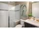 Modern bathroom featuring a glass-enclosed shower with a built-in bench and a sleek vanity at 722 Hutchinson St, Louisville, CO 80027