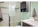Bathroom featuring shower with glass door, modern vanity and tiled accent wall at 722 Hutchinson St, Louisville, CO 80027