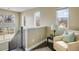Bright hallway with a cozy armchair, stylish rug, and plenty of natural light from the windows at 722 Hutchinson St, Louisville, CO 80027