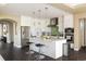 Bright kitchen features a large island with seating, modern appliances, and stylish white cabinetry at 722 Hutchinson St, Louisville, CO 80027