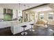 Bright kitchen featuring a large island, stainless steel appliances, and open dining space at 722 Hutchinson St, Louisville, CO 80027