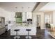 Modern kitchen with stainless steel appliances, a large island, and barstool seating at 722 Hutchinson St, Louisville, CO 80027