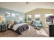 Bright main bedroom with sitting area, vaulted ceilings, and multiple windows with natural light at 722 Hutchinson St, Louisville, CO 80027