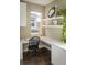 Bright office nook featuring a built-in desk, shelving, and natural light from the window at 722 Hutchinson St, Louisville, CO 80027