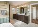 Double sink vanity in the main bathroom, featuring sleek fixtures and a granite countertop at 722 Hutchinson St, Louisville, CO 80027