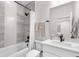 Modern bathroom with a stylish shower-tub combination and sleek fixtures and decor at 9140 Moondance Dr, Littleton, CO 80125