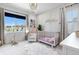 Adorable Bedroom with a crib, plush chair, and decorative shelving, perfect for a cozy and inviting space at 9140 Moondance Dr, Littleton, CO 80125