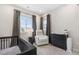 Welcoming Bedroom featuring a crib, chair, and plenty of natural light, creating a comfortable environment at 9140 Moondance Dr, Littleton, CO 80125